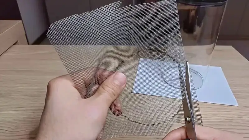Cutting the mesh for the jar terrarium