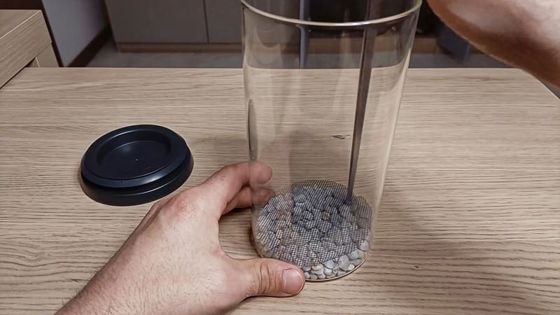 Adding the mesh to the jar terrarium
